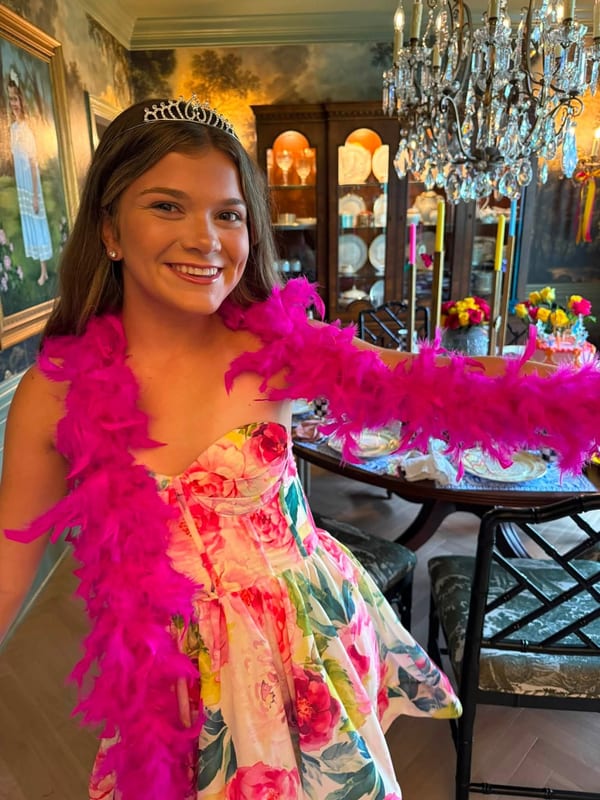 Caroline in a floral dress with tiara at a celebration